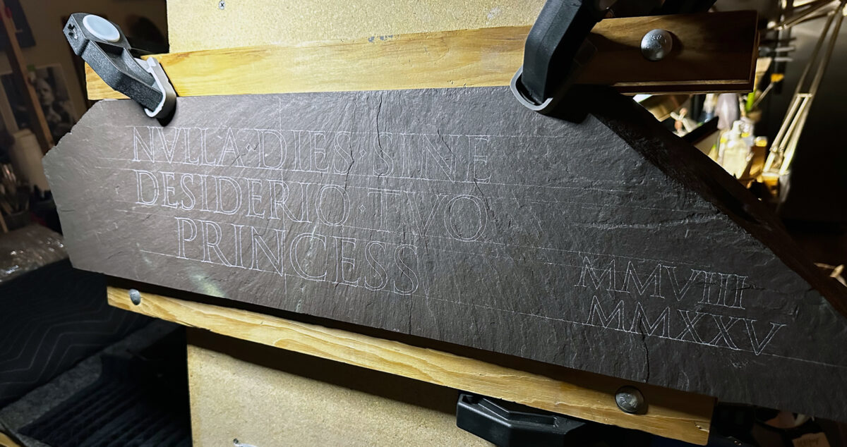 Lettering transferred to a slate tablet, ready to be carved.