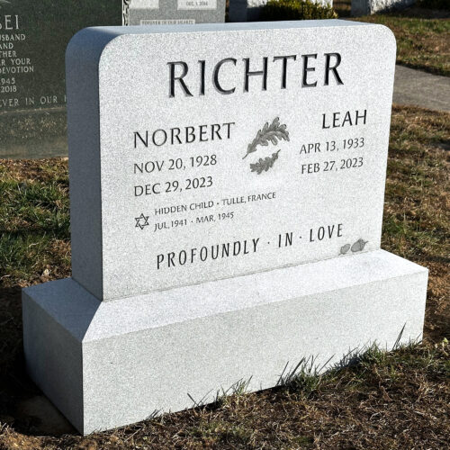 A medium shot of an installed granite memorial. Letters carved and painted.