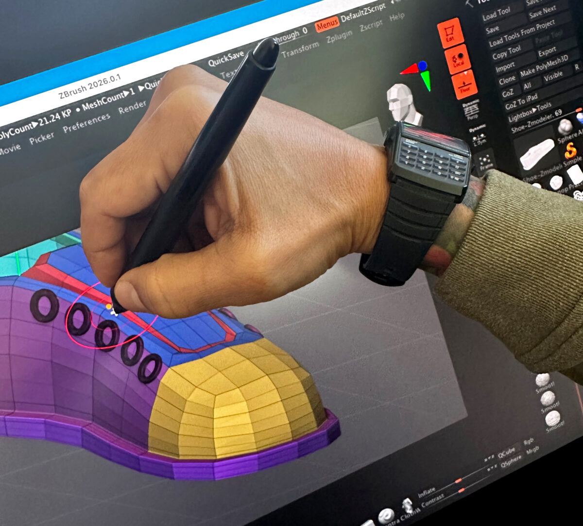 Detail of artist hand modeling a shoe using zbrush
