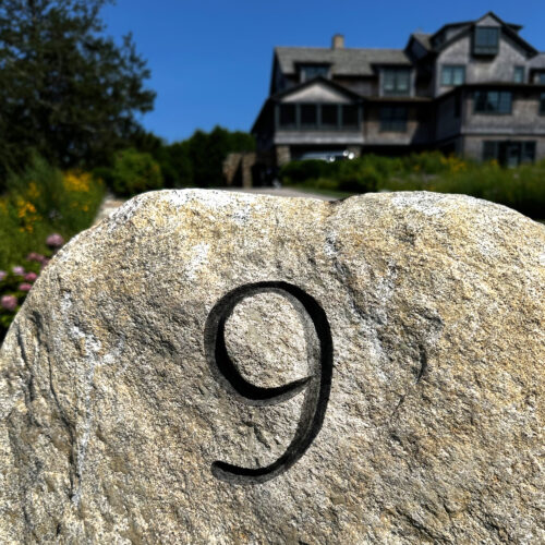 House number carved on a granite boulder, then mineral spirits added for a light shadow. Watch Hill, RI