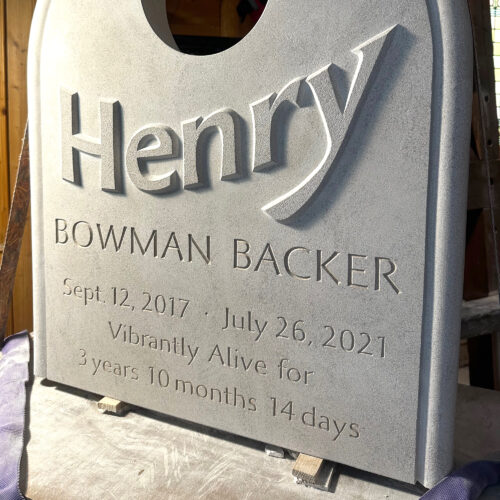 Full limestone memorial with raised letters carved, as well as incised letters.