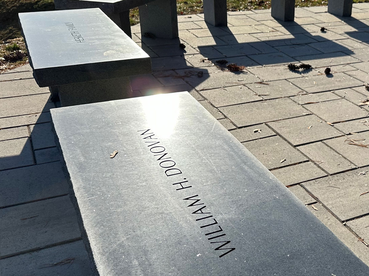Granite benches shot from a down perspective. Hnadcarved lettering of donors on each bench.